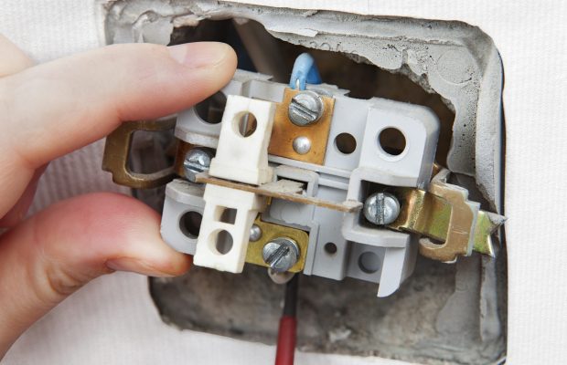 Dismantling and replacing an old, defective wall power switch light.